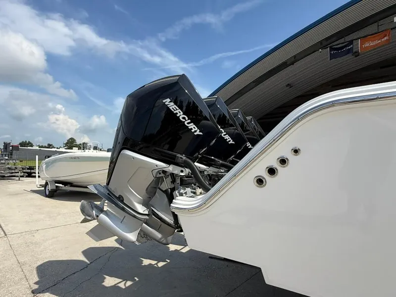 Slide: The Image of 2024 Front Runner 39 CC boat with Mercury engines, docked under a clear blue sky. - 10