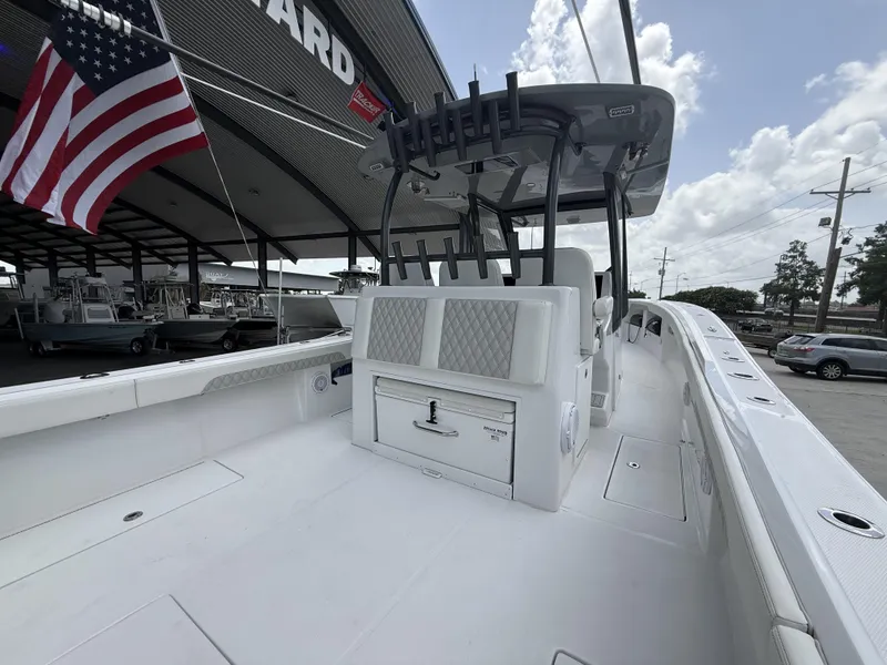 Slide: The Image of 2024 Front Runner 39 CC boat with American flag, docked under a covered area. - 28