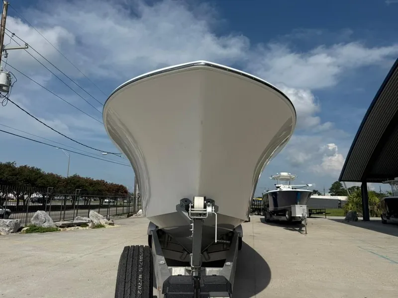Slide: The Image of 2024 Front Runner 39 CC boat on trailer, viewed from the front under a clear sky. - 6
