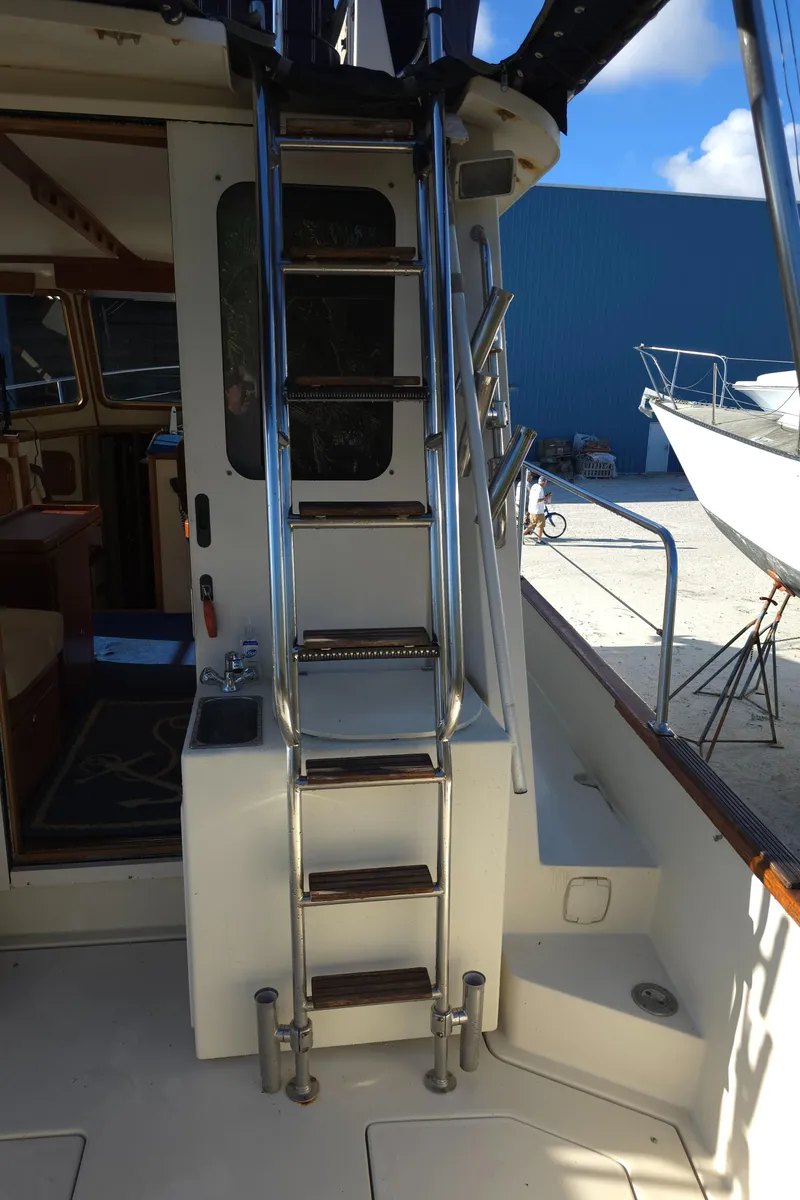 Slide: The Image of Stainless steel ladder on 2004 Legacy Sedan Flybridge boat, leading to upper deck. - 17