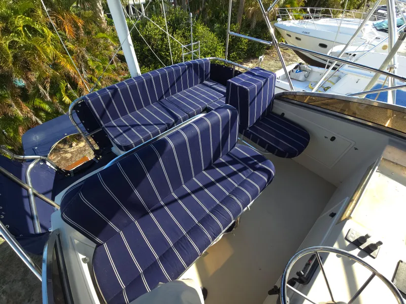 Slide: The Image of 2004 Legacy Sedan Flybridge with striped seating, featuring a spacious and comfortable layout. - 22