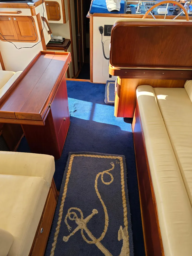 Slide: The Image of Interior of 2004 Legacy Sedan Flybridge with blue carpet and wooden furnishings. - 26