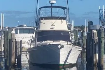 Slide: The Image of 2004 Legacy Sedan Flybridge boat docked at marina under clear blue sky. - 3