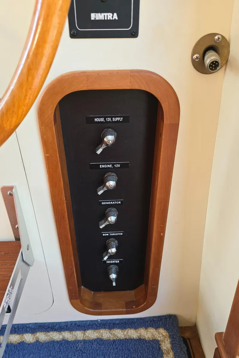 Slide: The Image of Control panel with switches in a 2004 Legacy Sedan Flybridge boat interior. - 31