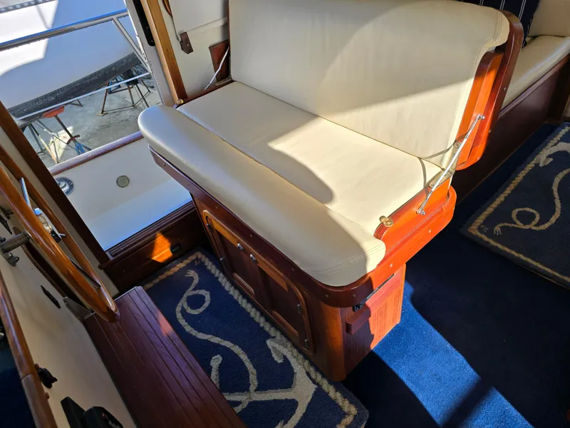 Slide: The Image of Interior of 2004 Legacy Sedan Flybridge with wooden accents and cushioned seating. - 32