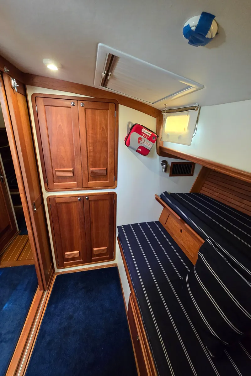 Slide: The Image of Interior of 2004 Legacy Sedan Flybridge with wooden cabinets and striped seating. - 39