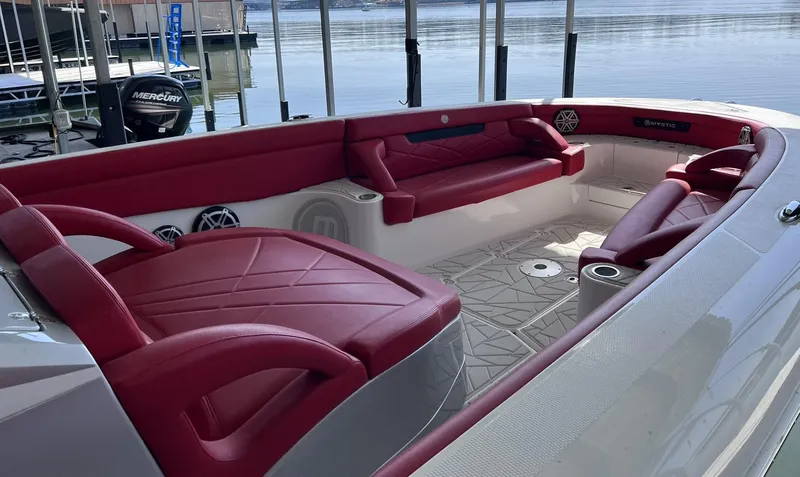Slide: The Image of 2019 Mystic Powerboats M4200 with luxurious red seating and spacious deck area. - 10