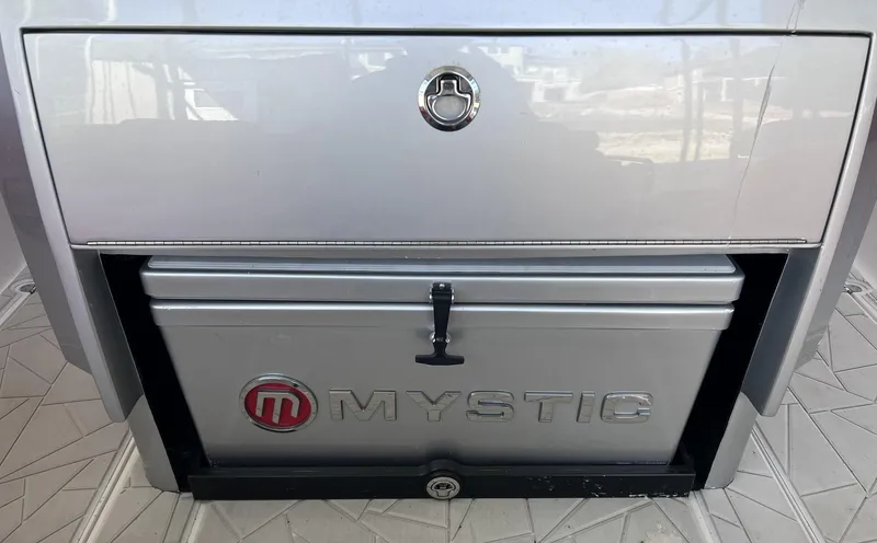 Slide: The Image of 2019 Mystic Powerboats M4200 storage compartment with logo on a sleek, modern design. - 14