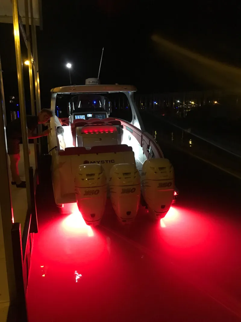 Slide: The Image of 2019 Mystic Powerboats M4200 with red underwater lights at night. - 20