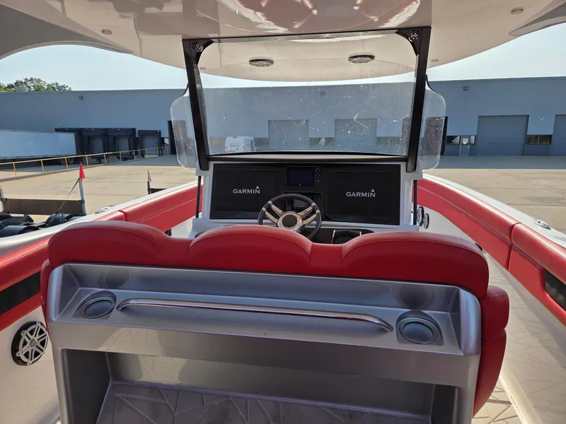 Slide: The Image of 2019 Mystic Powerboats M4200 cockpit with red seating and Garmin navigation system. - 25