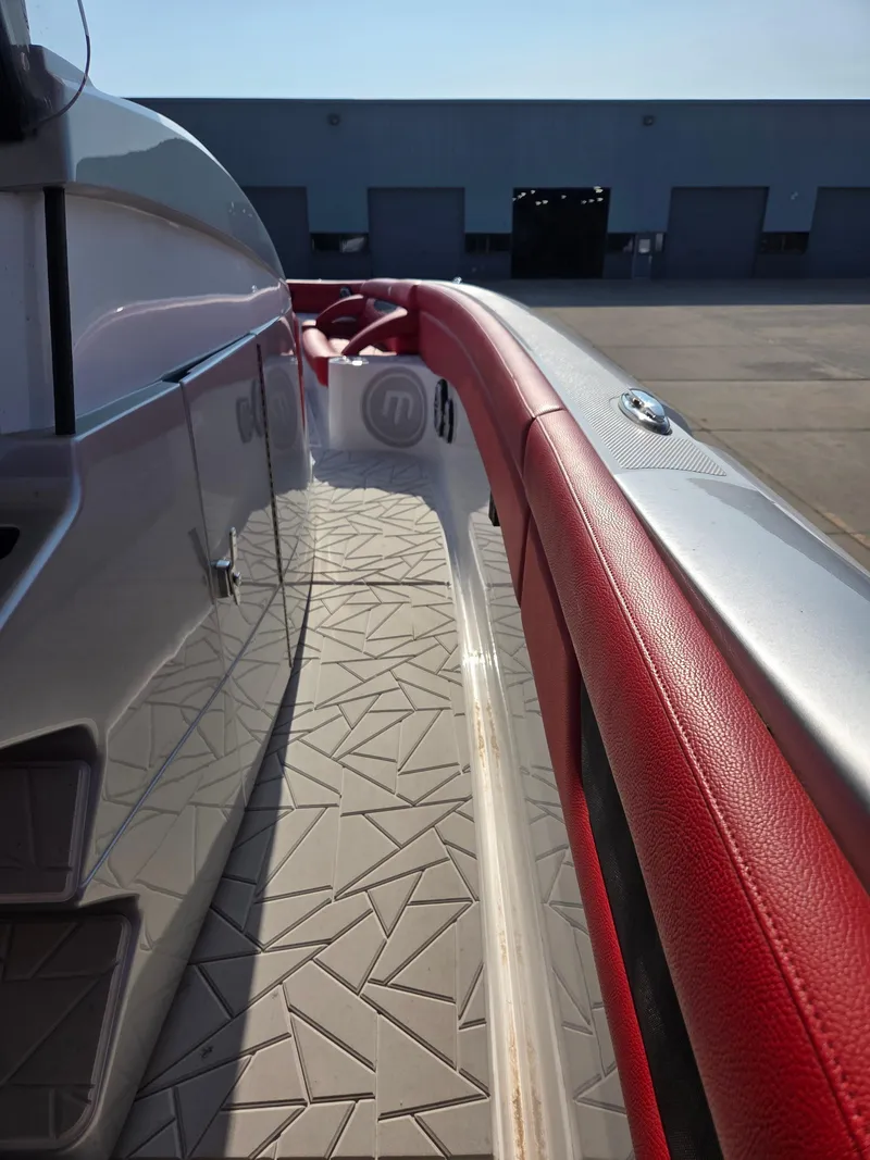 Slide: The Image of 2019 Mystic Powerboats M4200 with red trim and geometric flooring design. - 26