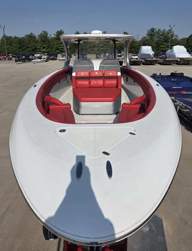 Slide: The Image of 2019 Mystic Powerboats M4200 with red seating, docked outdoors. - 27