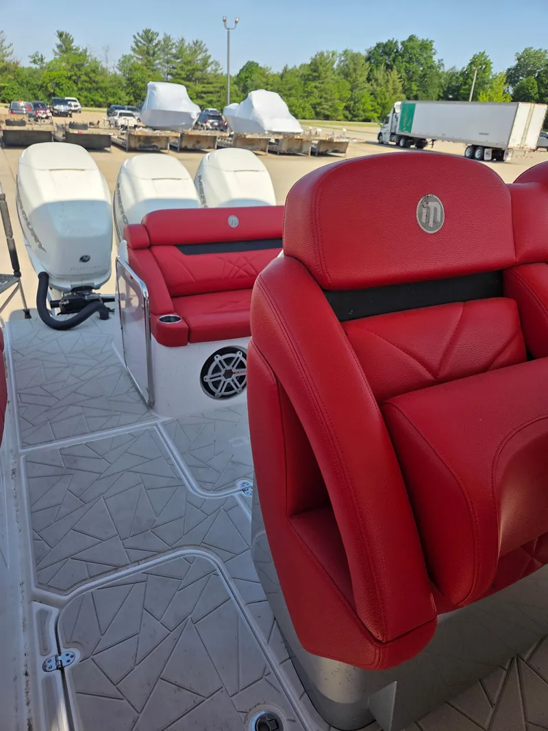 Slide: The Image of 2019 Mystic Powerboats M4200 with red leather seats and powerful outboard engines. - 5