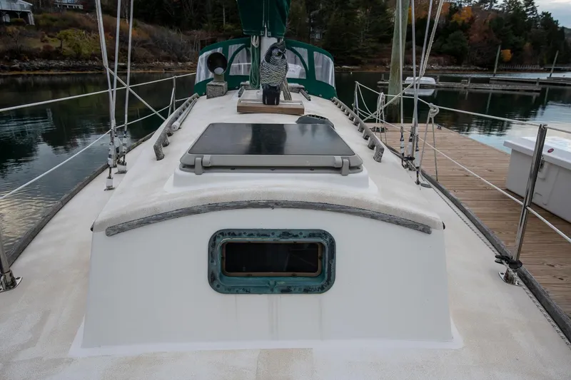 Slide: The Image of Sailboat deck view, Morris Linda 28, 1988 model, docked in a serene marina setting. - 12