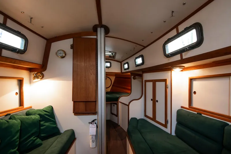 Slide: The Image of Interior of 1988 Morris Linda 28 sailboat with green cushions and wooden accents. - 16