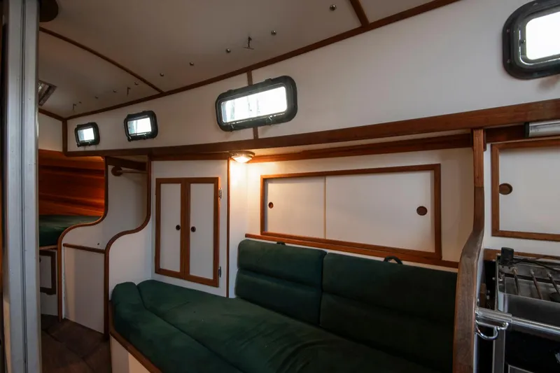 Slide: The Image of Interior of 1988 Morris Linda 28 sailboat with green seating and wooden accents. - 17