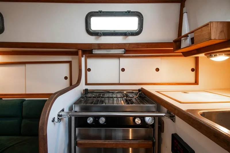 Slide: The Image of Interior of 1988 Morris Linda 28 yacht with stove, sink, and wooden cabinetry. - 19