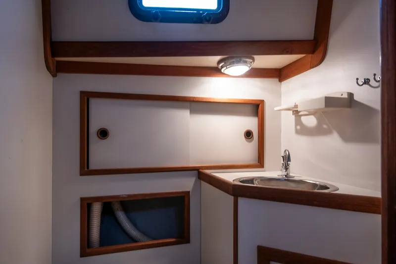 Slide: The Image of Compact bathroom interior of 1988 Morris Linda 28 boat with sink and storage. - 23