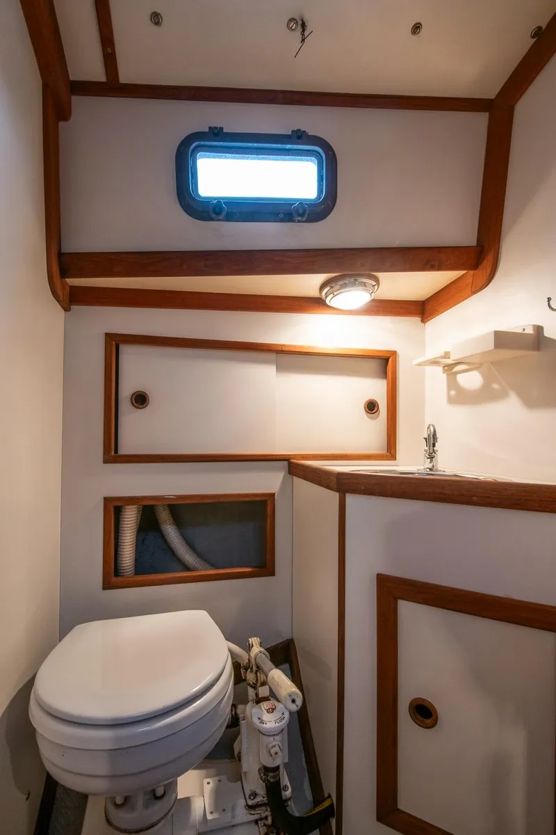 Slide: The Image of Compact bathroom in 1988 Morris Linda 28 boat with wooden trim and porthole window. - 24