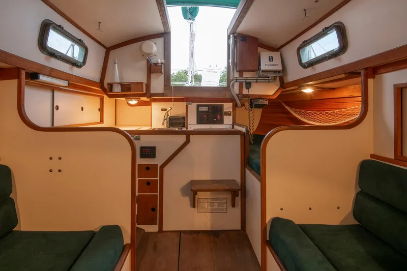 Slide: The Image of Interior of 1988 Morris Linda 28 sailboat with cozy seating and wooden accents. - 28