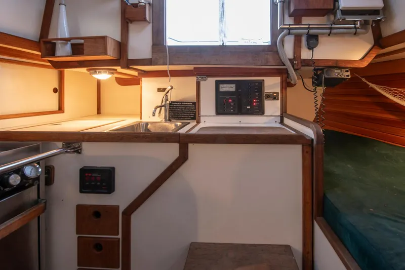 Slide: The Image of 1988 Morris Linda 28 yacht interior with kitchen, sink, and control panel. - 30