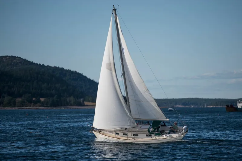 Slide: The Image of Sailboat Morris Linda 28 (1988) cruising on a scenic lake with mountainous backdrop. - 36