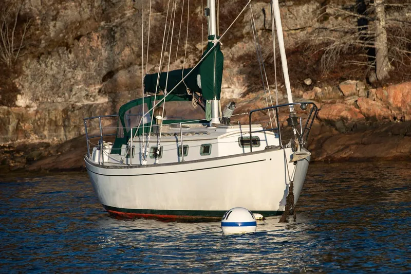 Slide: The Image of Sailboat "Morris Linda 28" from 1988 anchored near rocky shoreline. - 4