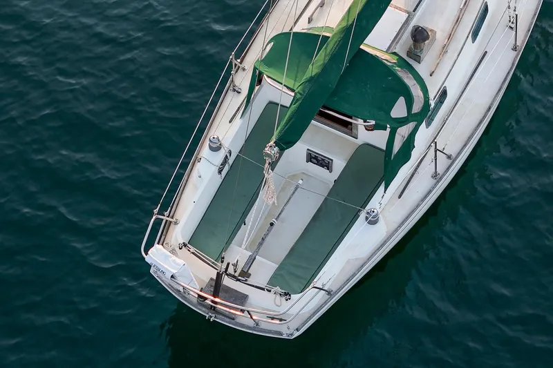 Slide: The Image of Aerial view of 1988 Morris Linda 28 sailboat with green sails on calm water. - 7