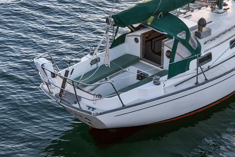 Slide: The Image of 1988 Morris Linda 28 sailboat with green canopy on calm water. - 8