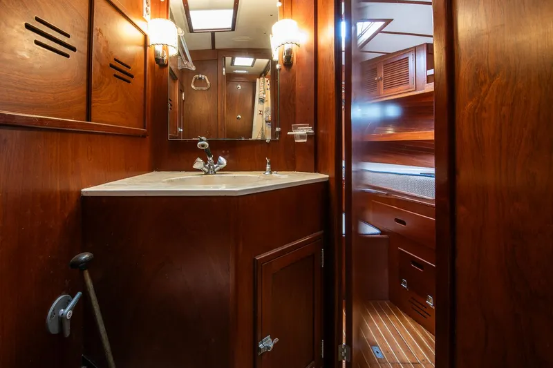 Slide: The Image of 1976 Hinckley SW50 yacht interior with wooden cabinetry and bathroom sink. - 25