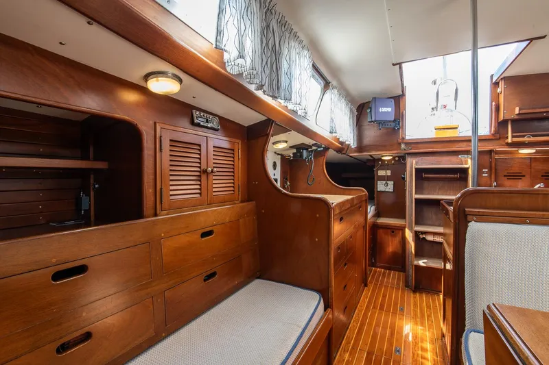 Slide: The Image of Interior of 1976 Hinckley SW50 sailboat with wooden cabinetry and seating. - 26