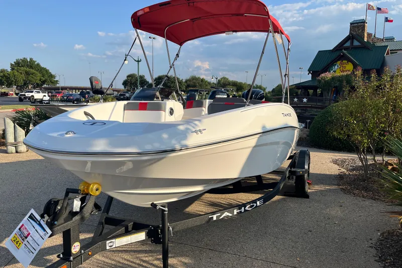 The Image of 2025 Tahoe T16 boat with red canopy on display outdoors. - 0