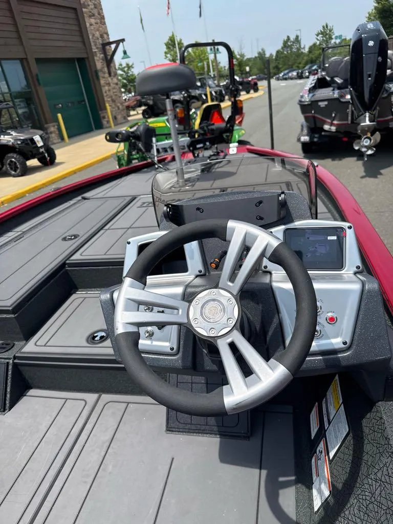 Slide: The Image of 2025 Tracker Savage 215 boat interior with modern steering wheel and dashboard controls. - 6