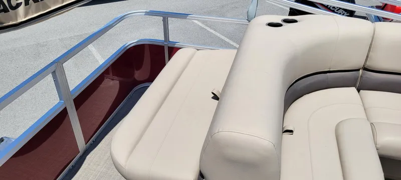 Slide: The Image of 2025 Sun Tracker Party Barge 18 DLX with beige seating and cup holders. - 4