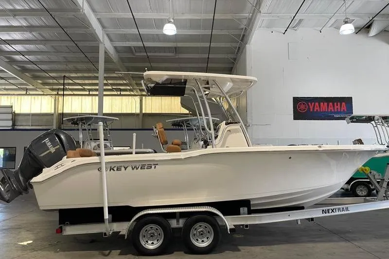 The Image of 2025 Key West 239 FS boat on trailer in indoor showroom with Yamaha engine. - 0