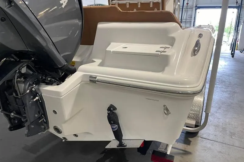 Slide: The Image of 2025 Key West 239 FS boat stern with outboard motor in a garage setting. - 11