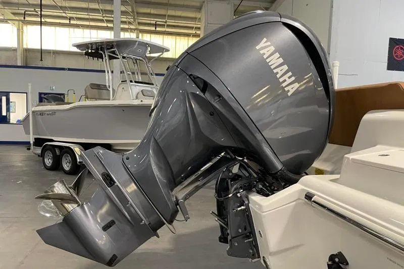 Slide: The Image of 2025 Key West 239 FS boat with Yamaha outboard motor in a showroom. - 12
