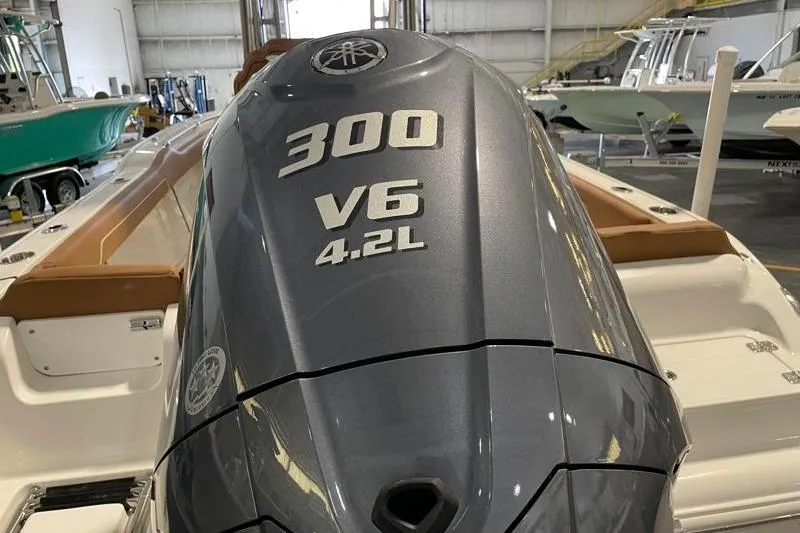 Slide: The Image of 2025 Key West 239 FS boat with 300 V6 4.2L engine in a showroom. - 14