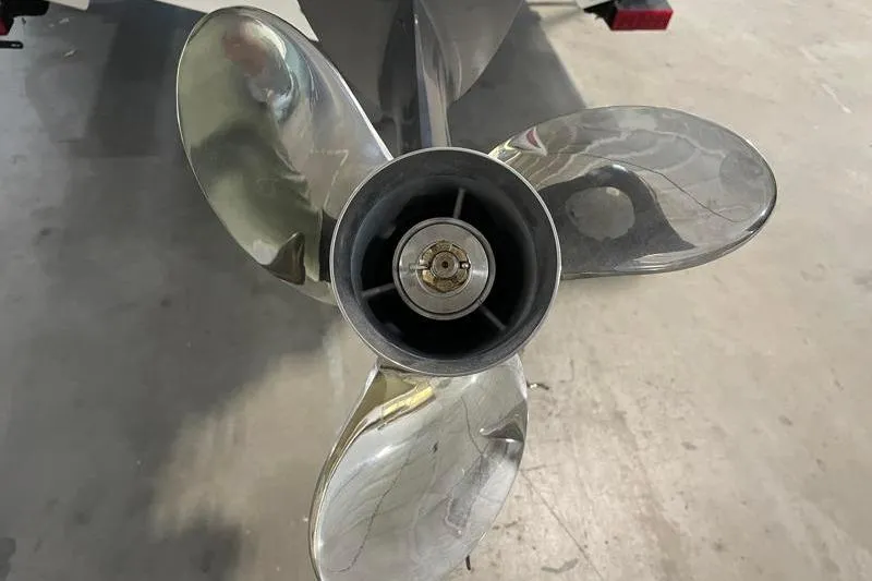 Slide: The Image of Close-up of a 2025 Key West 239 FS boat propeller in a garage setting. - 15