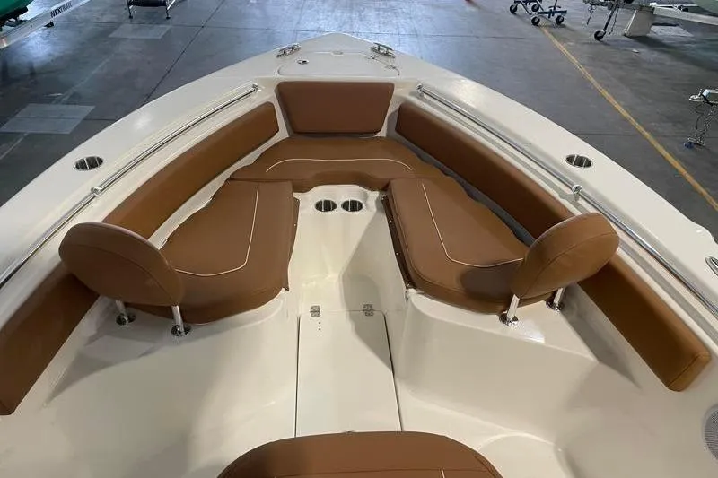 Slide: The Image of 2025 Key West 239 FS boat interior with brown cushioned seating and stainless steel fixtures. - 19
