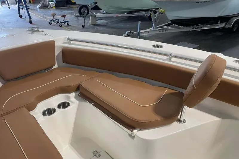 Slide: The Image of 2025 Key West 239 FS boat interior with brown cushioned seating and cup holders. - 20