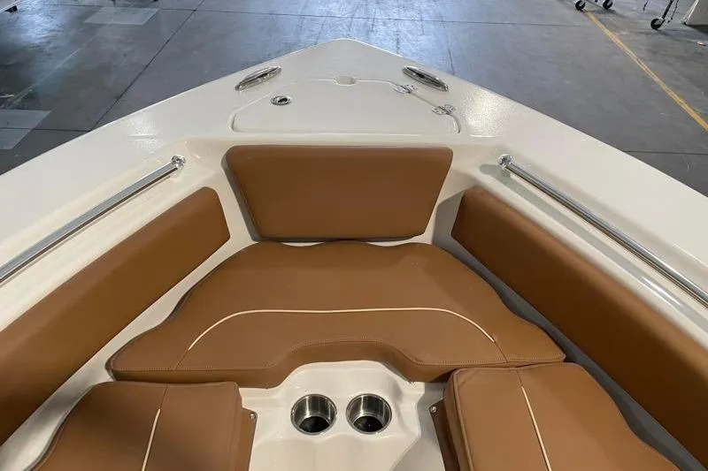 Slide: The Image of 2025 Key West 239 FS boat interior with tan seating and stainless steel cup holders. - 22