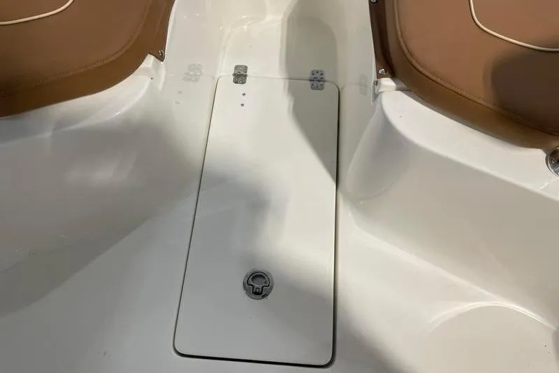 Slide: The Image of 2025 Key West 239 FS boat interior with brown seating and storage compartment. - 23