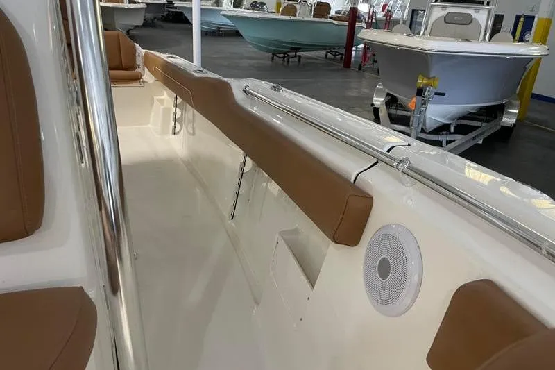 Slide: The Image of 2025 Key West 239 FS boat interior with tan seating and speaker. - 26