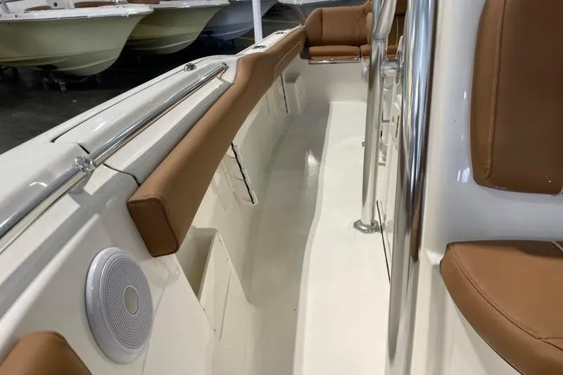 Slide: The Image of 2025 Key West 239 FS boat interior with brown seating and stainless steel railings. - 27