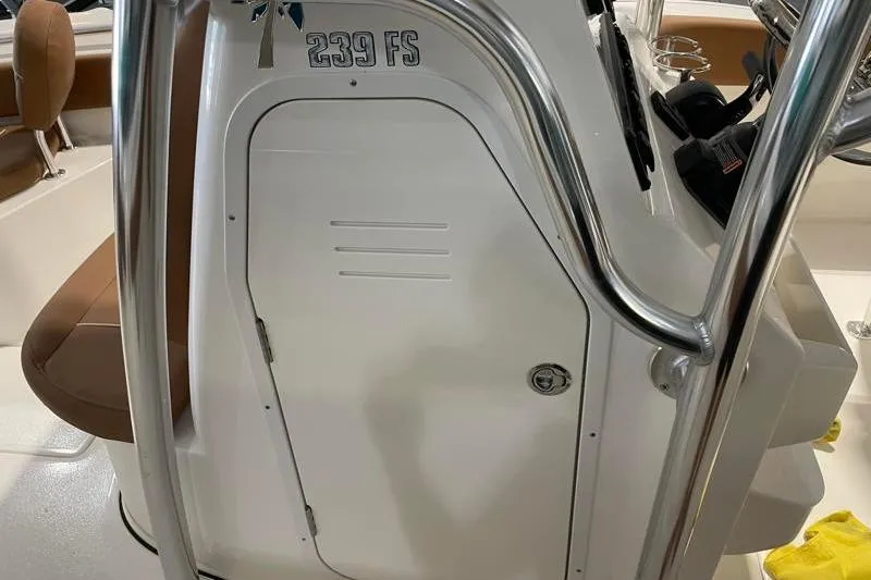 Slide: The Image of 2025 Key West 239 FS boat console with stainless steel railings and storage compartment. - 28