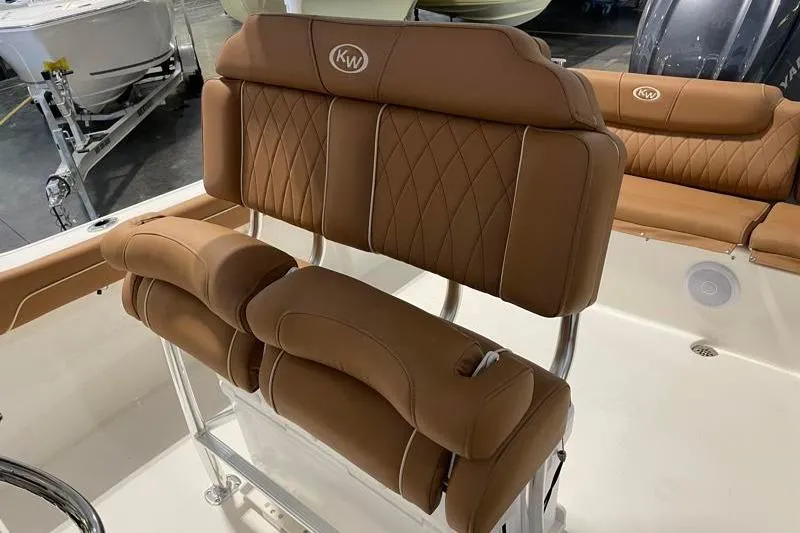 Slide: The Image of 2025 Key West 239 FS boat interior with tan cushioned seating and stainless steel frame. - 30