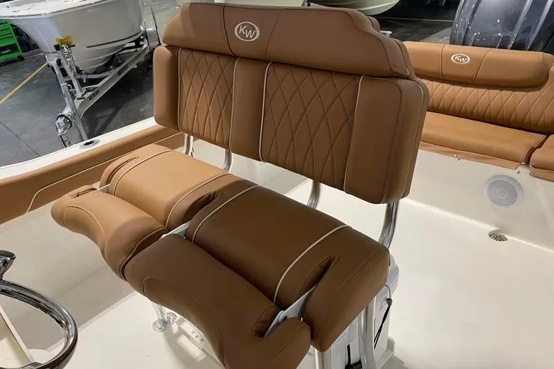 Slide: The Image of 2025 Key West 239 FS boat interior with brown cushioned seating. - 31