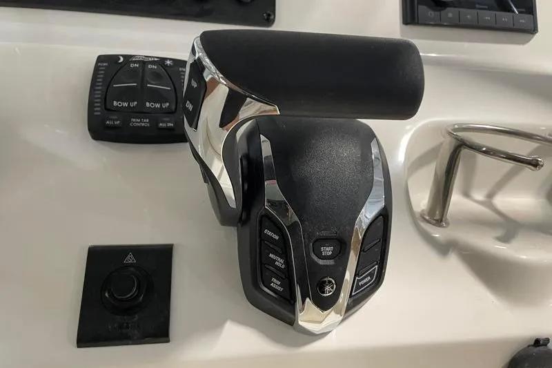 Slide: The Image of Close-up of 2025 Key West 239 FS boat throttle controls on dashboard. - 37