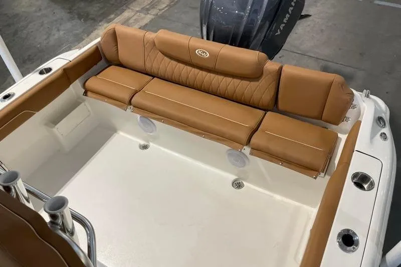 Slide: The Image of 2025 Key West 239 FS boat with tan cushioned seating and Yamaha engine. - 38